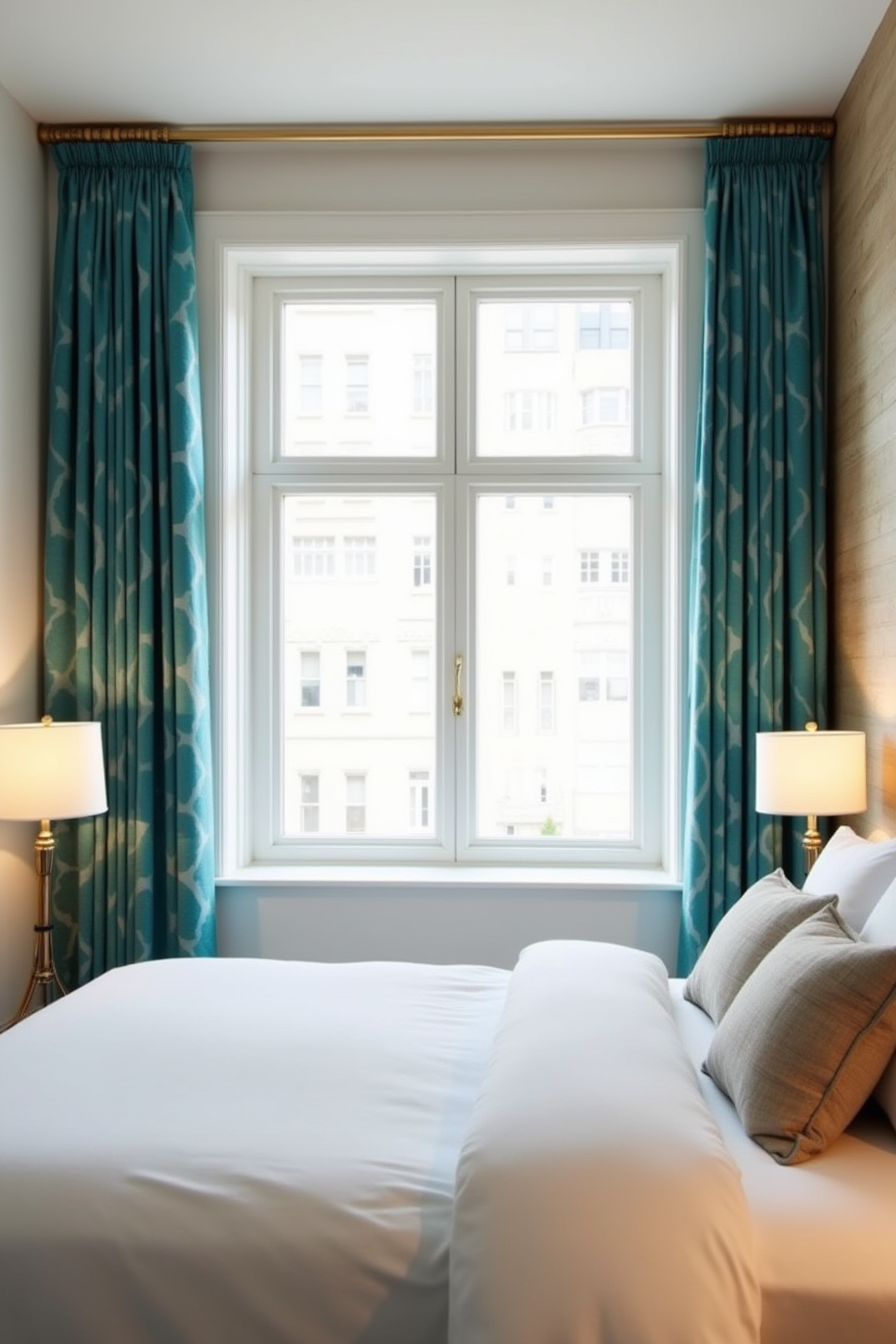 Jewel-tone teal patterned curtain panels frame a window on an accent wall above white bedding, pulled open to the sides.
