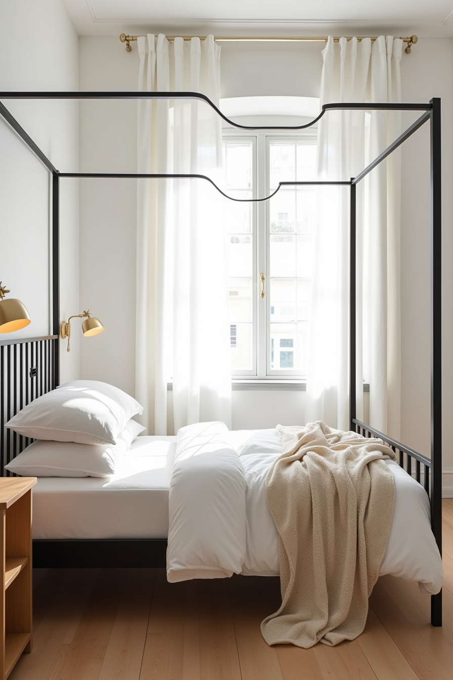 Black metal four-poster bed with white linens and cream throw beside a wooden nightstand.