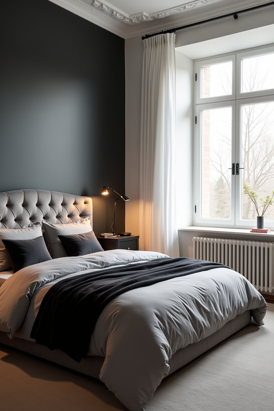 Tufted gray velvet headboard with black pillows and gray duvet against a matte black bedroom wall.