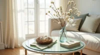 Round glass table with ceramic nest of speckled eggs, pussy willow branches in vase, and sage linen napkin.