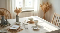 Cream tablecloth topped with galvanized vases of dried pampas, enamel heart dishes, and burlap garland.