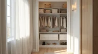 White shelving units in a narrow closet hold folded sweaters, storage bins, hanging coats, and shoes.