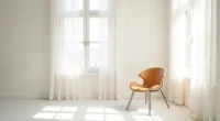 Angular chair with metal legs in white room corner viewed from above.