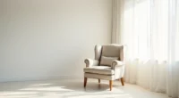 Wingback chair with rolled armrests and wooden legs viewed from above in a white corner, casting shadows on the floor.
