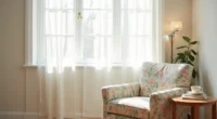 Botanical-print accent chair angled in corner with wooden side table holding a ceramic mug, lit by natural window light.