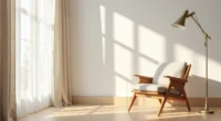 Teak wood accent chair with tapered legs casts sharp shadows on oak flooring against a linen wall.